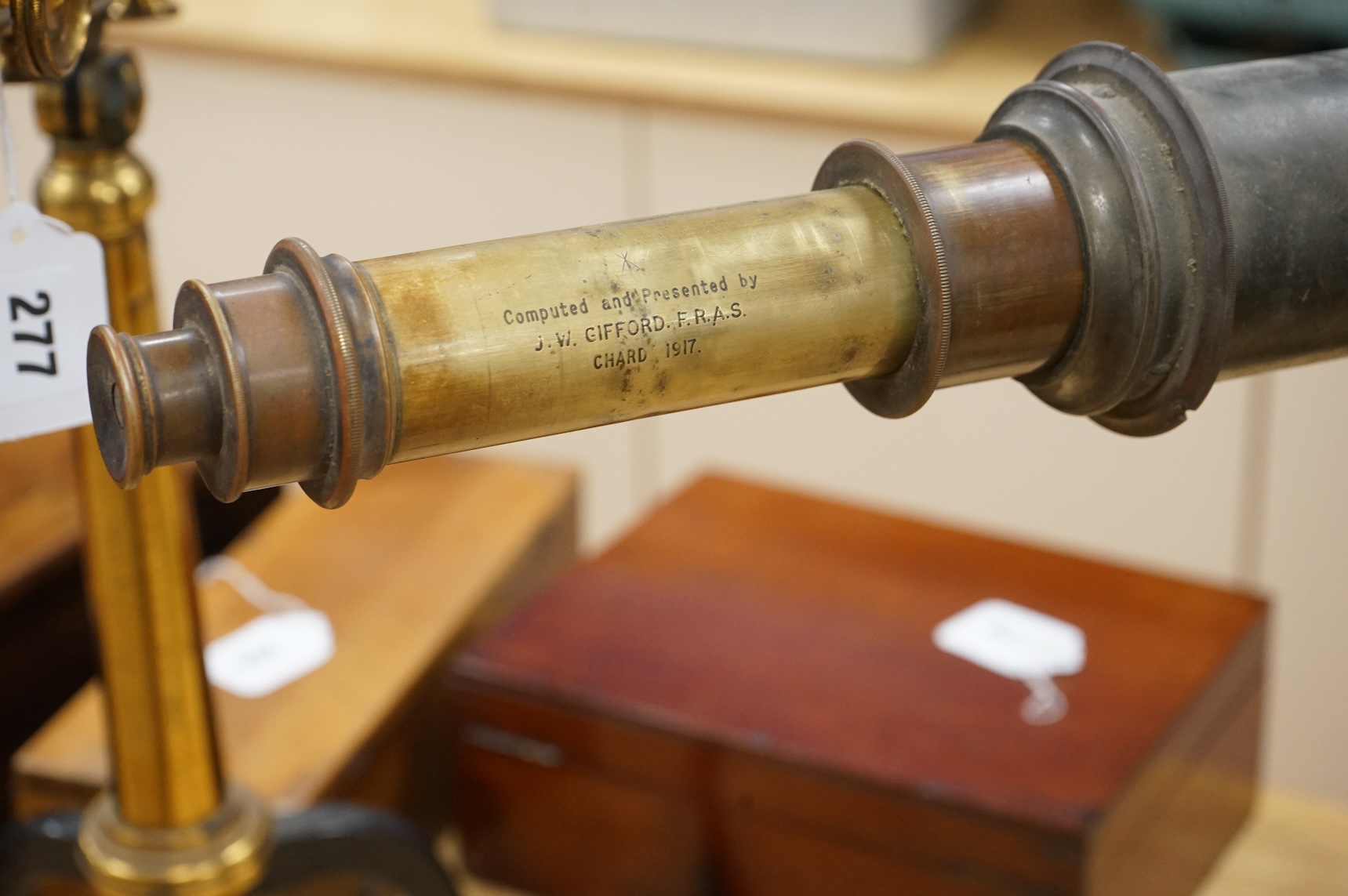 An early 20th century brass two draw telescope on tabletop tripod stand, with engraved dedication; ‘ Computed and Presented by J.W. Gifford. F.R.A.S. Chard 1917’, 73cm long, 48cm high on stand.